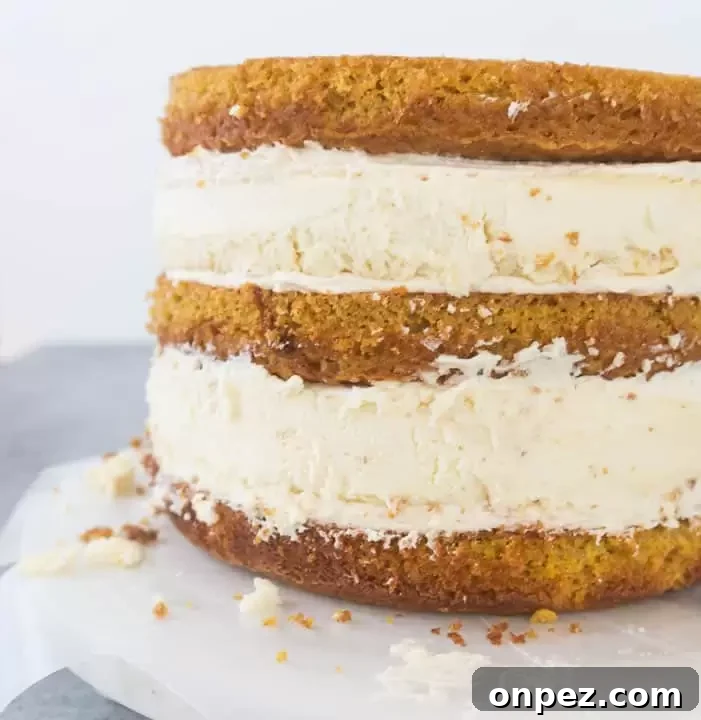 Decadent Pumpkin Cheesecake Layer Cake with Caramel Frosting 4 unfrosted pumpkin cheesecake layer cake with all of the layers stacked