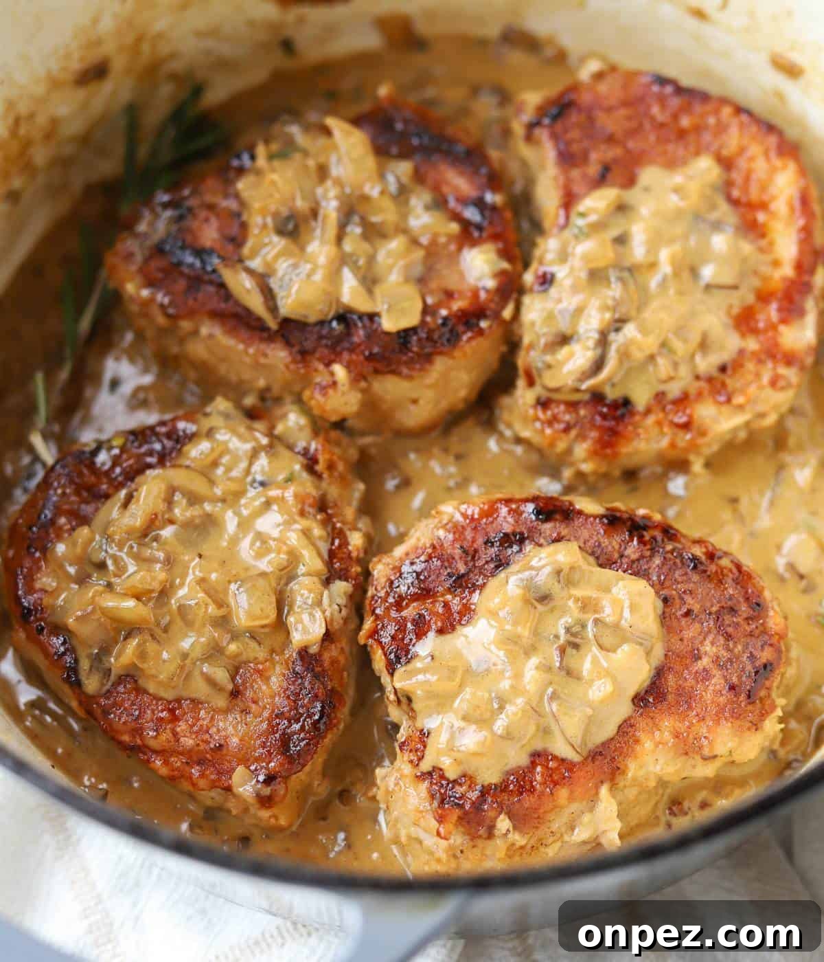 Dutch Oven Pork Chops with Tender Gravy 2 Smothered pork chops in mushroom gravy.