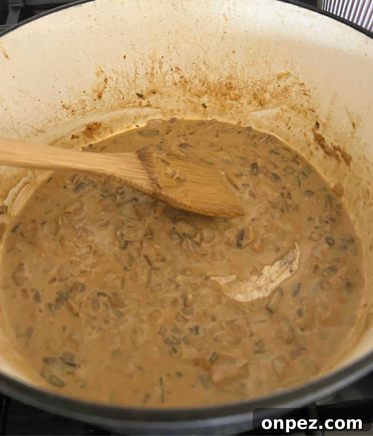 Dutch Oven Pork Chops with Tender Gravy 10 Mushroom gravy in pot.