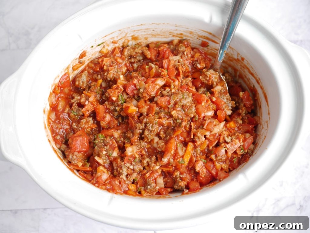 Copycat Olive Garden Three-Meat Sauce in the Crockpot 6 Stirred sauce ready to cook