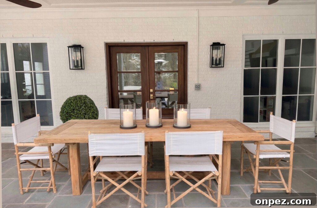 Six Yohana folding director chairs around a teak dining table on a covered patio