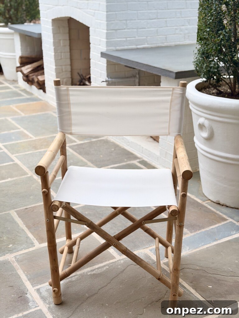 Close up of Yohana folding director chair with bamboo frame and white canvas seat