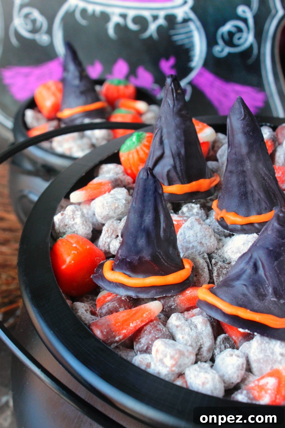 Halloween Witch Hat Puppy Chow Snack Mix 4 Adding candy pieces to the mix