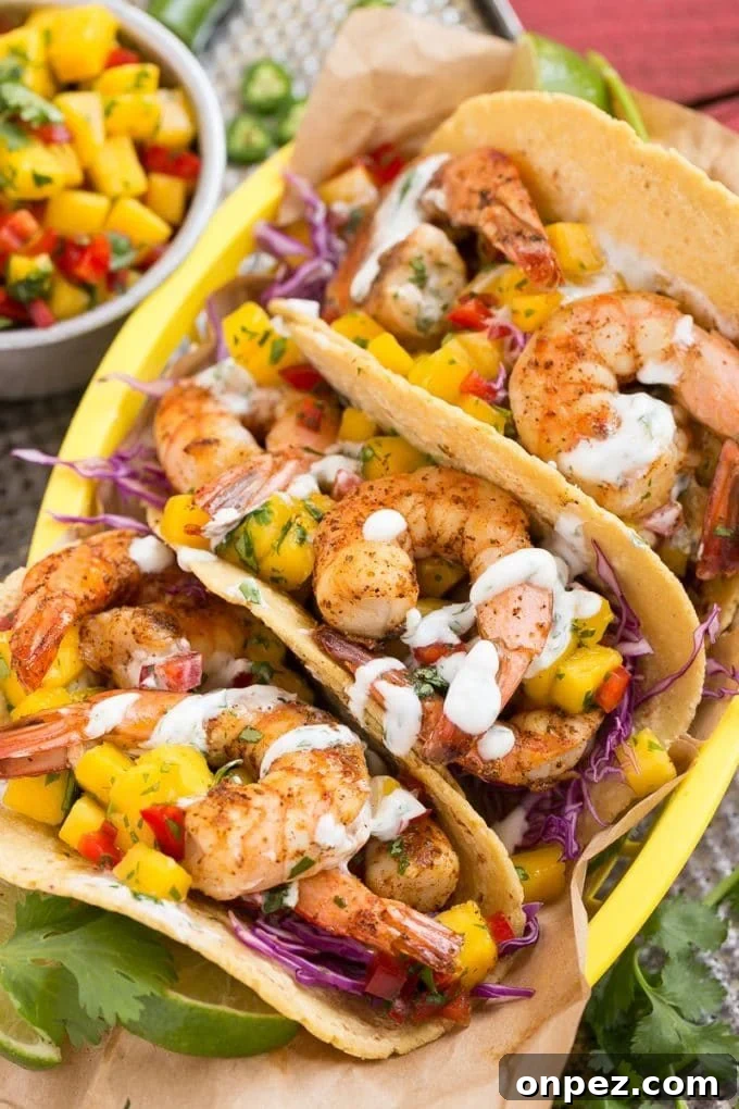 Shrimp tacos with fresh mango salsa and creamy sauce.