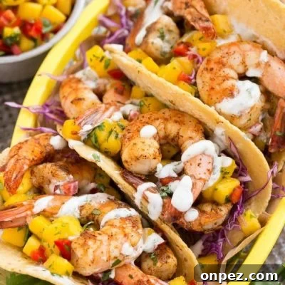 Shrimp tacos with sweet and tangy mango salsa and creamy cilantro lime sauce.