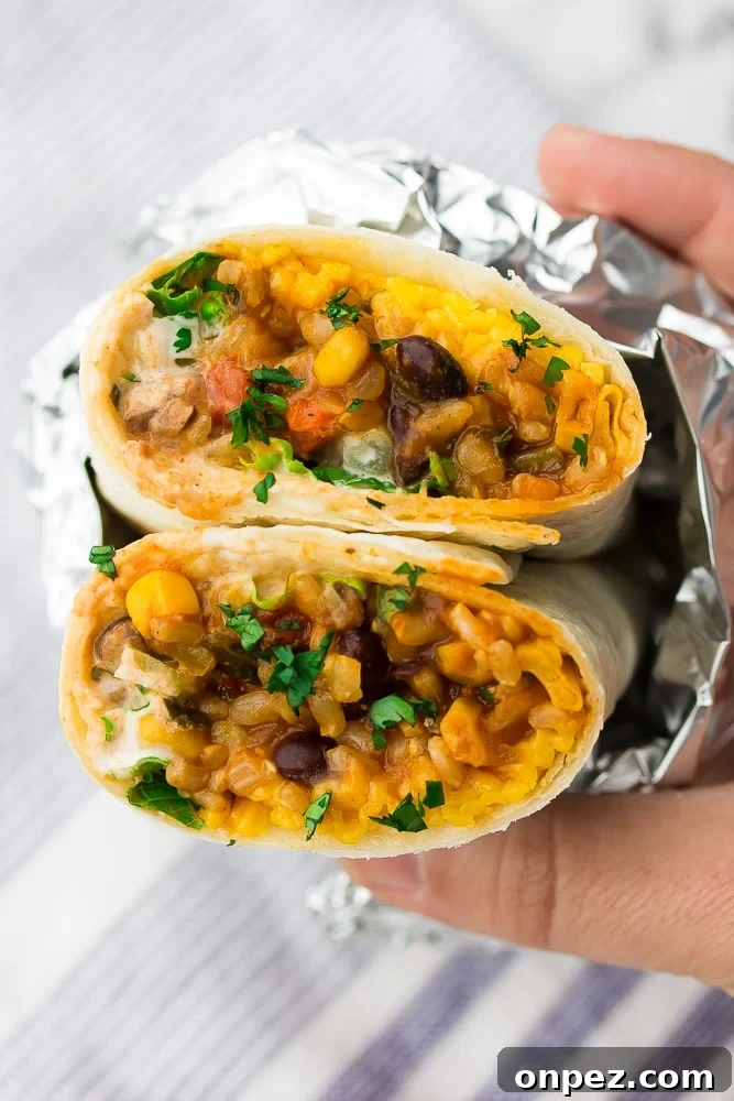 Vegan Burritos with Black Beans and Rice 2 close up of a burrito with colorful filling, wrapped in foil