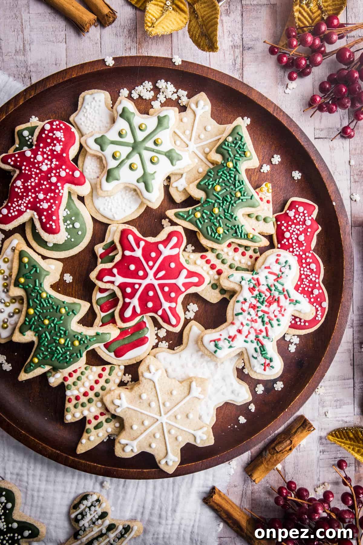 Gluten-Free Christmas Cookies for the Holidays 2 Wooden plate full of Christmas Cookies with Christmas Decorations surrounding