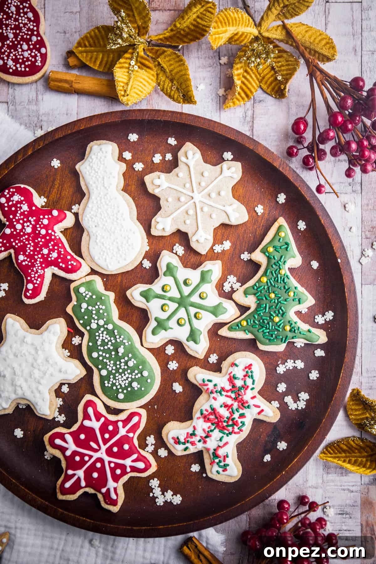 Gluten-Free Christmas Cookies for the Holidays 18 Wooden plate full of Christmas Cookies with Christmas Decorations surrounding