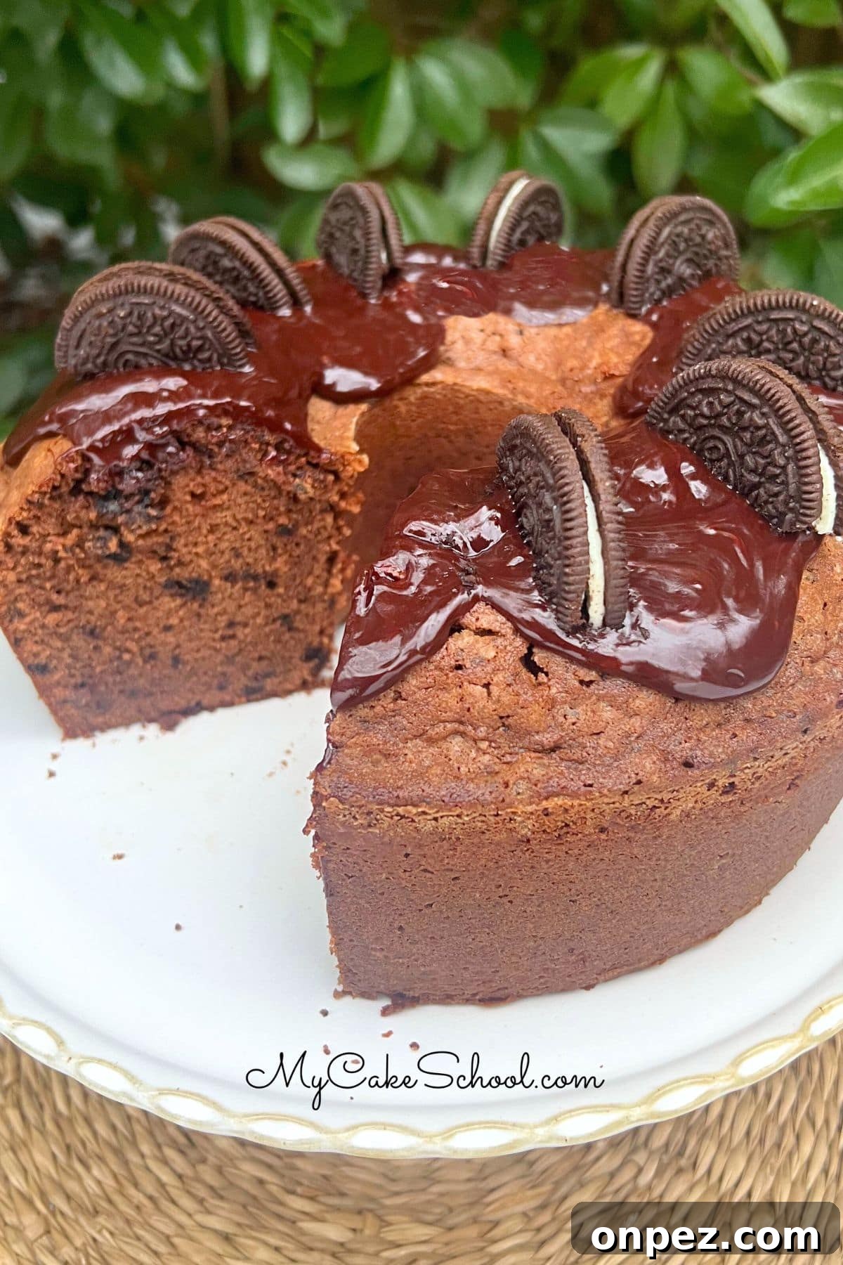 Chocolate Oreo Pound Cake Recipe 2 Chocolate Oreo Pound Cake, sliced, on a pedestal.