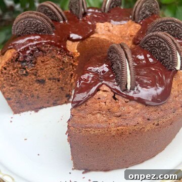 Chocolate Oreo Pound Cake Recipe 11 Chocolate Oreo Pound Cake, sliced, on a pedestal.