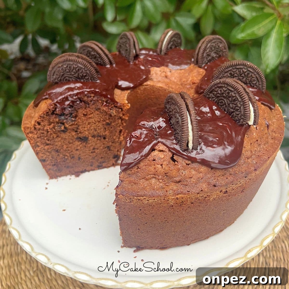 Chocolate Oreo Pound Cake Recipe 6 Chocolate Oreo Pound Cake, sliced, on a cake pedestal.