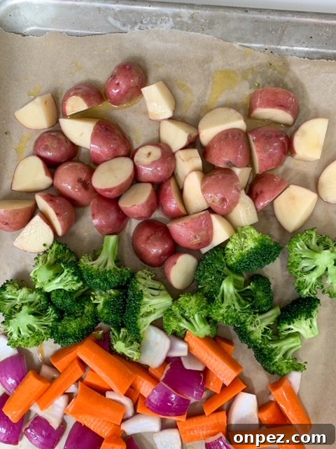 Spicy Sheet Pan Chicken Dinner with Vegetables 5 Vegetables arranged on a sheet pan before baking