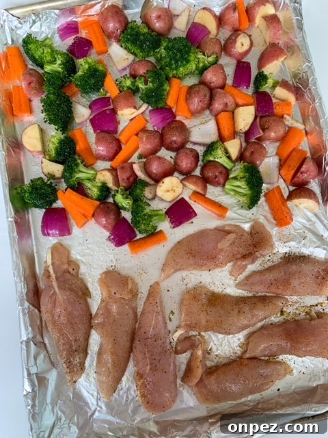 Spicy Sheet Pan Chicken Dinner with Vegetables 6 Seasoned chicken tenderloins added to a vegetable sheet pan dinner