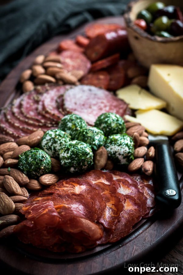 Garlic and Herb Marinated Olives Recipe 5 Charcuterie board with cured meats, herbed goat cheese balls, hard cheese, almonds and marinated olives