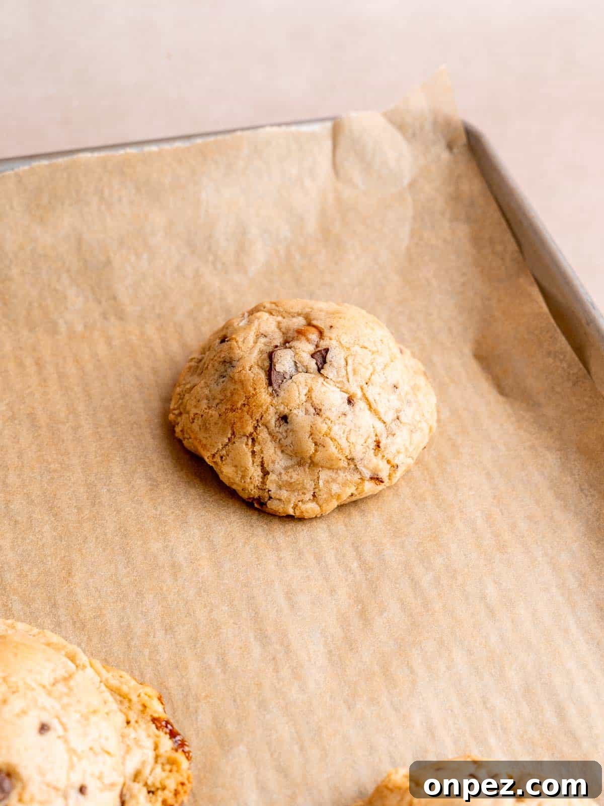Levain Bakery Copycat Caramel Coconut Chocolate Chip Cookies 9 Levain copycat caramel coconut chocolate chip cookies baked on a cookie sheet.