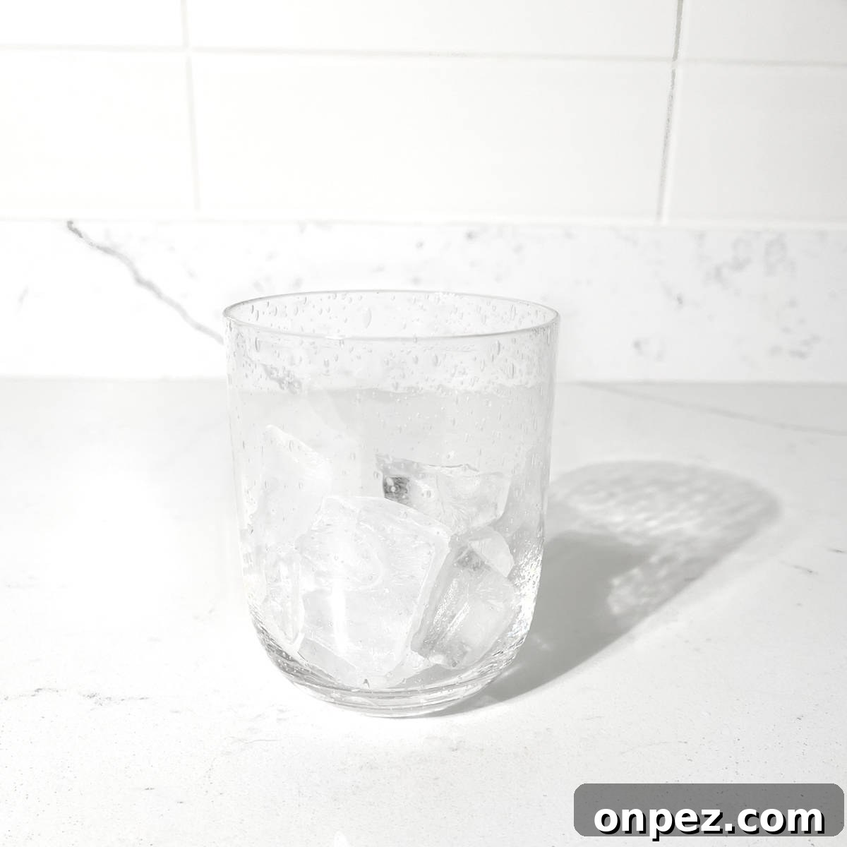 Classic Lemon Lime and Bitters Cocktail Recipe 4 Adding ice to a glass for the lemon lime bitters.