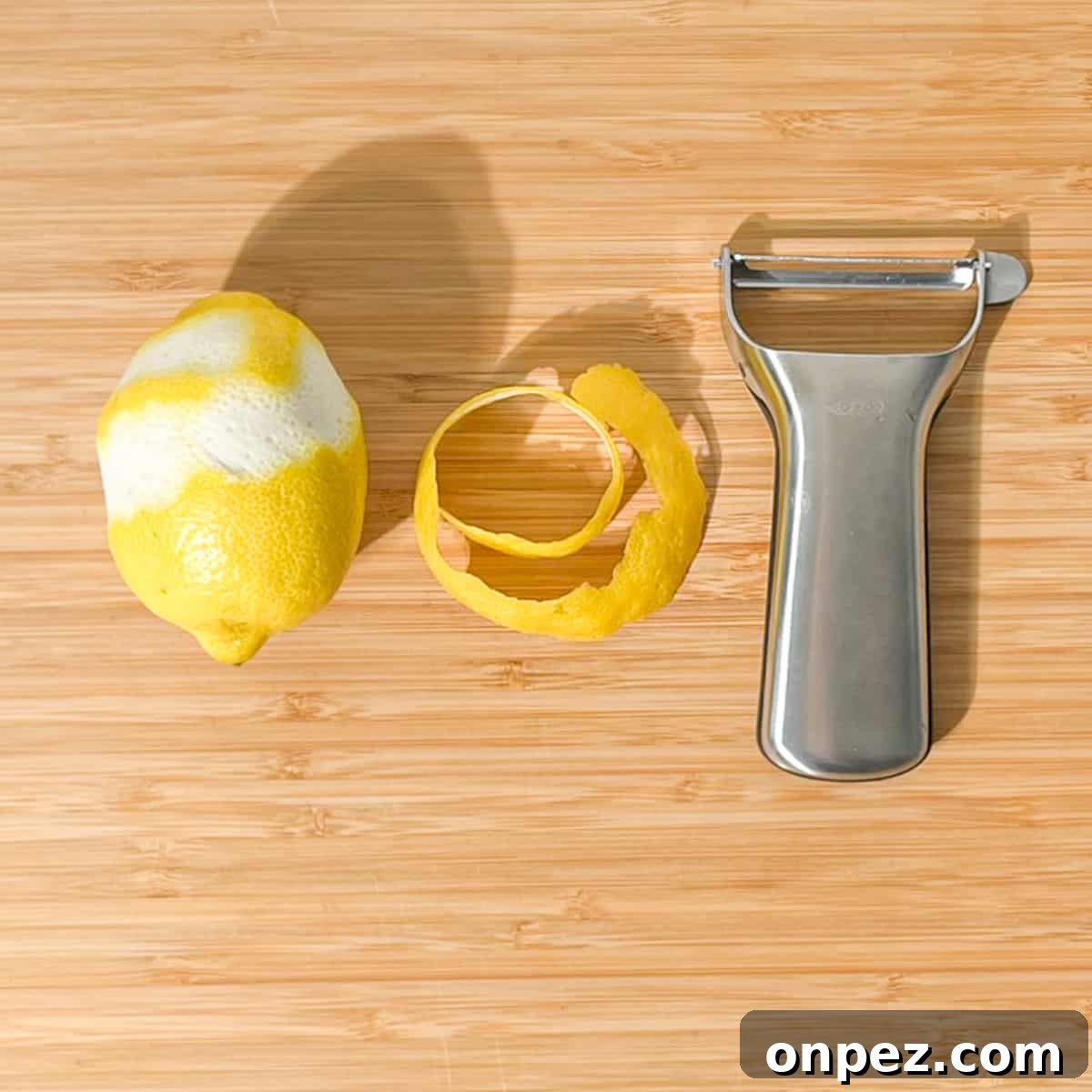 Classic Lemon Lime and Bitters Cocktail Recipe 8 Peeling a long length of lemon peel with a peeler.