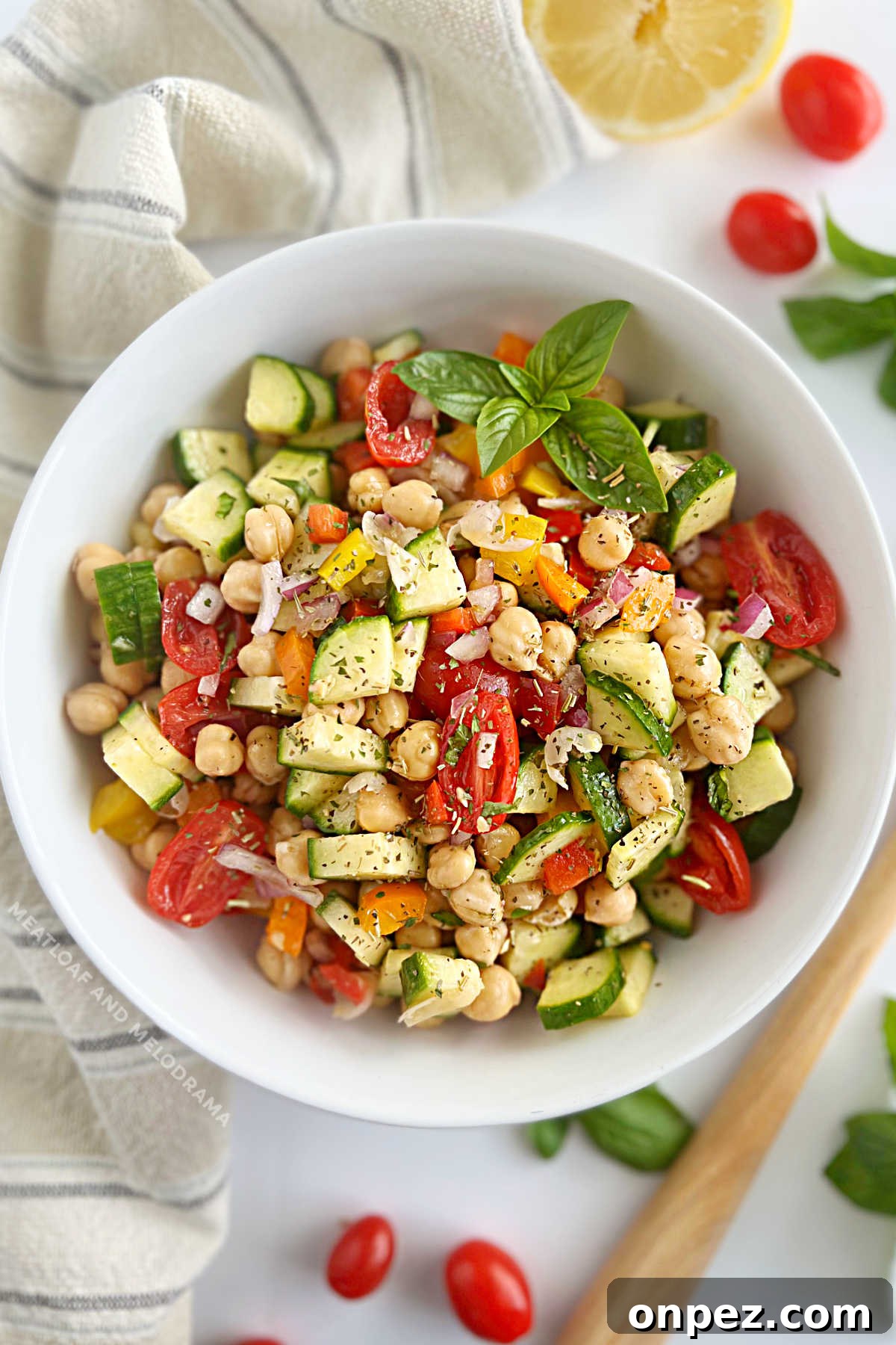 Mediterranean Chickpea Salad Recipe with Lemon and Herbs 2 simple chickpea salad with cucumbers, bell pepper, grape tomatoes, red onion and fresh herbs in bowl