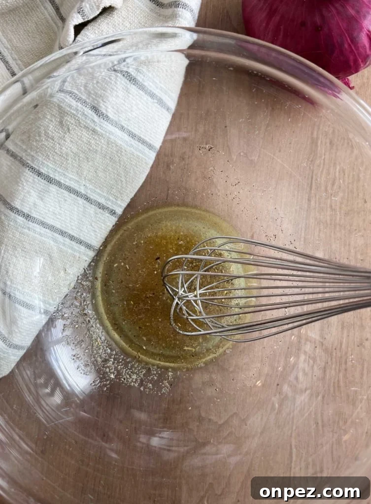 Mediterranean Chickpea Salad Recipe with Lemon and Herbs 4 whisk lemon dressing for chickpea salad in mixing bowl
