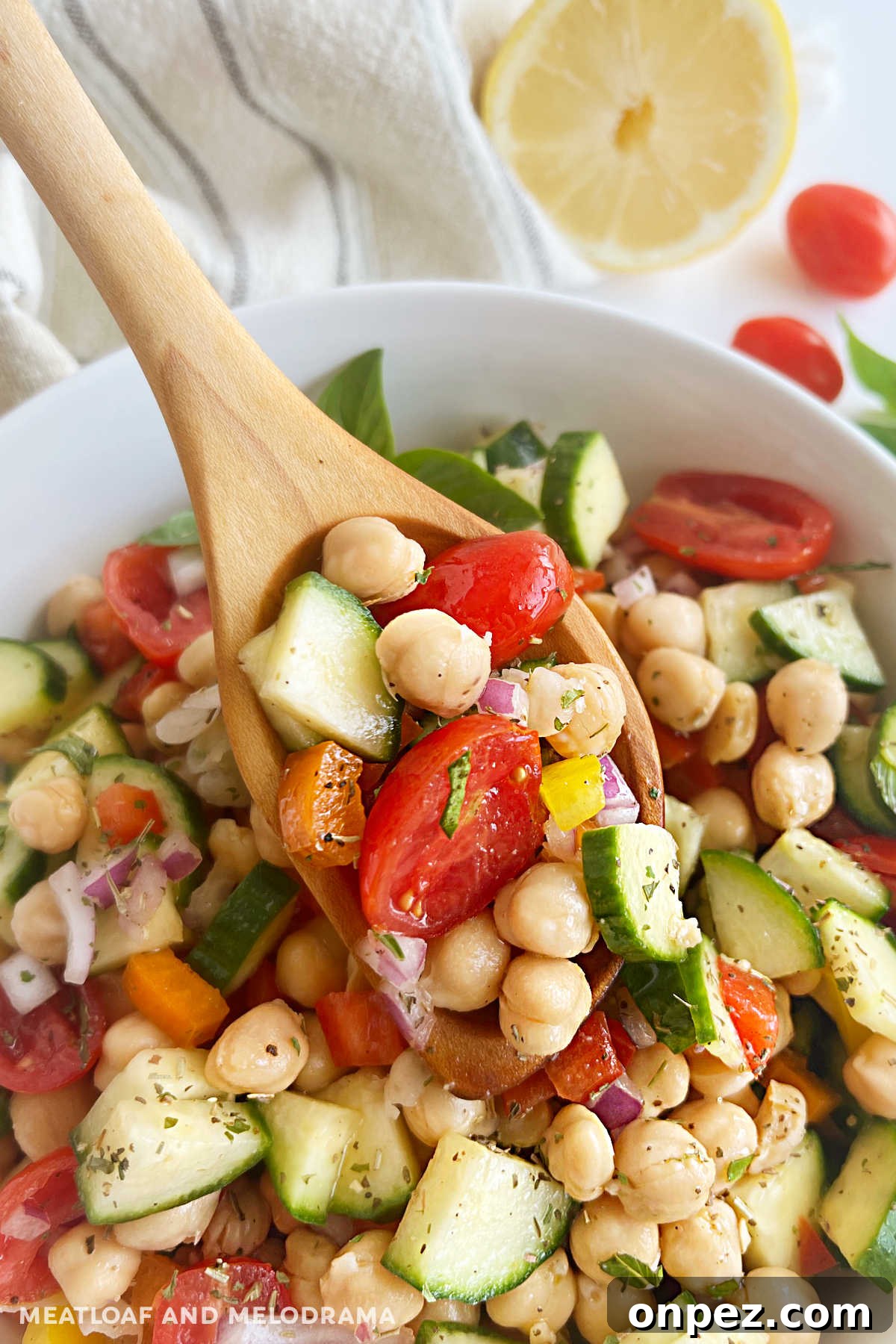 Mediterranean Chickpea Salad Recipe with Lemon and Herbs 7 chickpea salad on wooden spoon over serving bowl