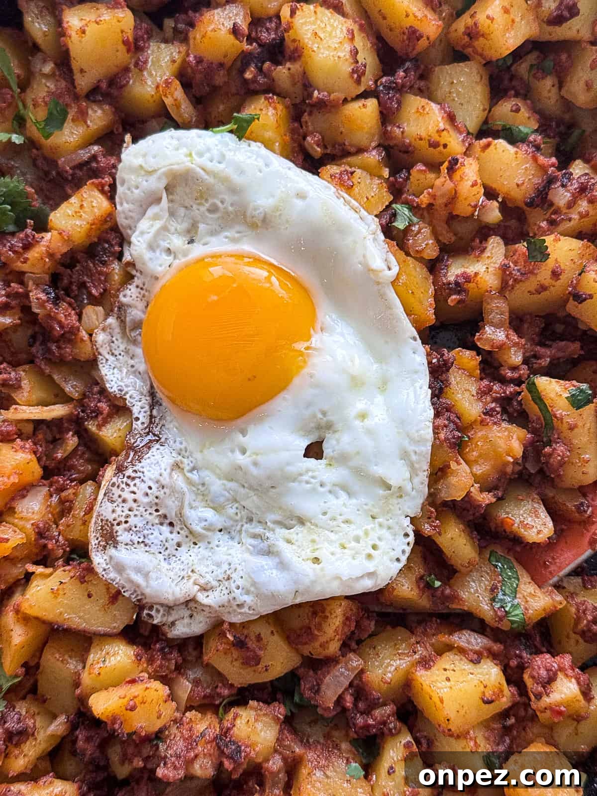 Papas con Chorizo Recipe: Spicy Chorizo and Potato Skillet 3 Closeup of sunny side up Egg with Chorizo and Potatoes
