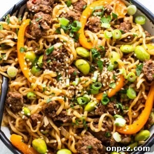 A bowl of noodles with meat and vegetables.