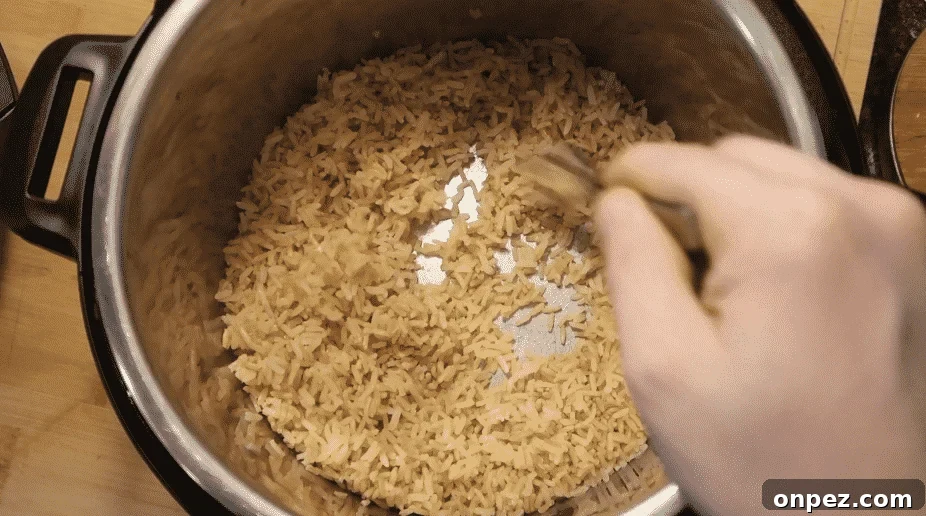 Instant Pot Brown Rice Recipe 10 Fluffing Instant Pot brown rice with a fork