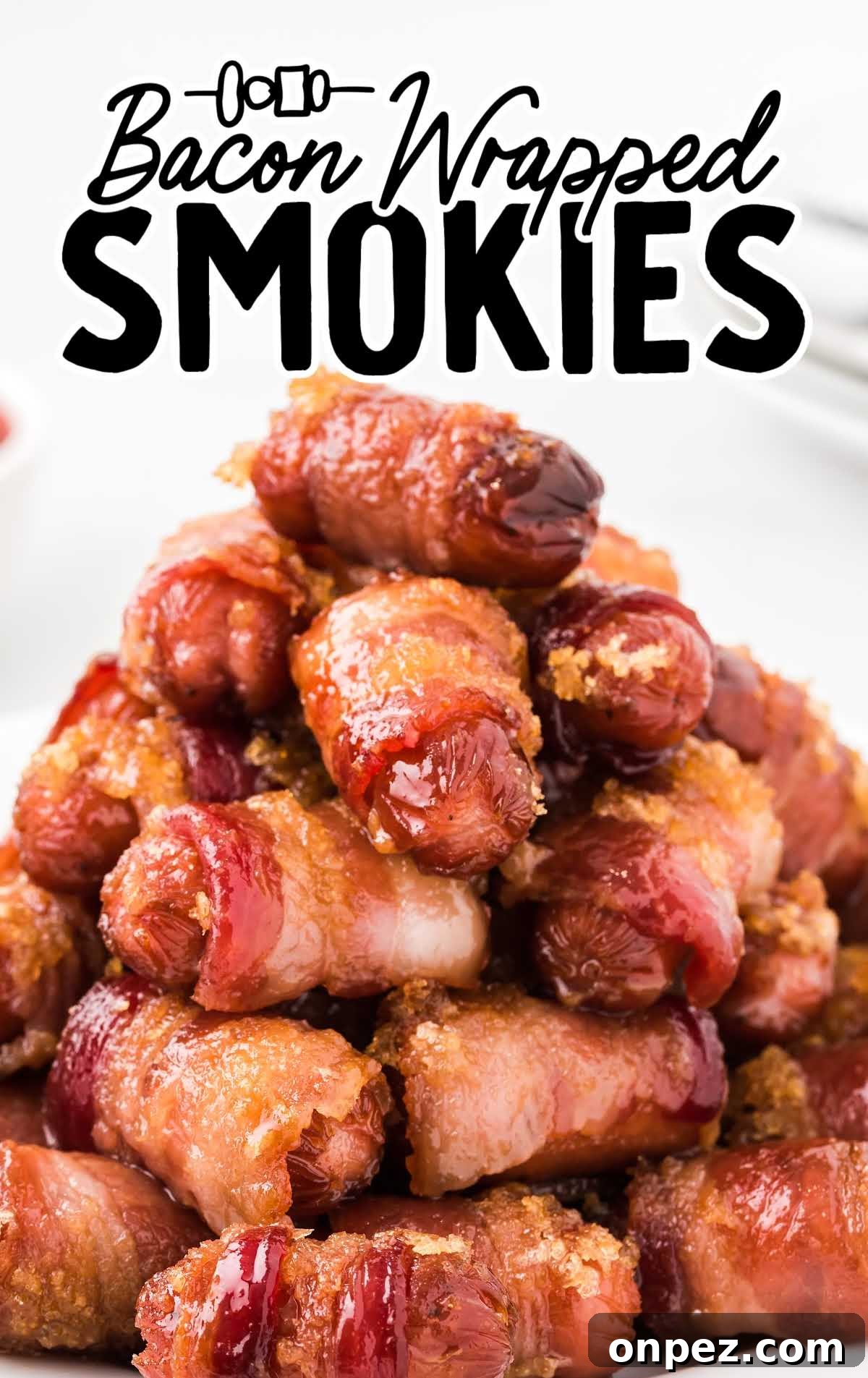 Brown Sugar Bacon-Wrapped Smokies — Crowd-Pleasing Appetizer 2 a close up shot of Bacon Wrapped Smokies staked on top of each other on a plate