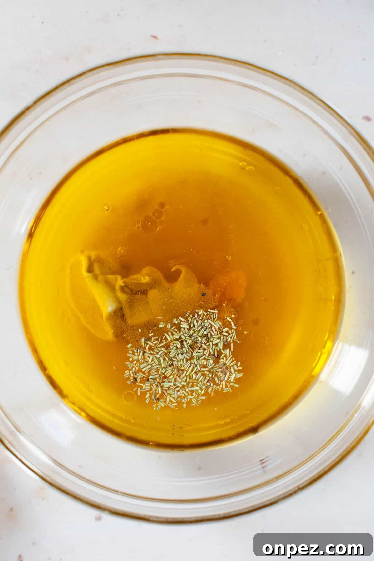 Dijon mustard and spices added to honey, vinegar and lemon juice mix.