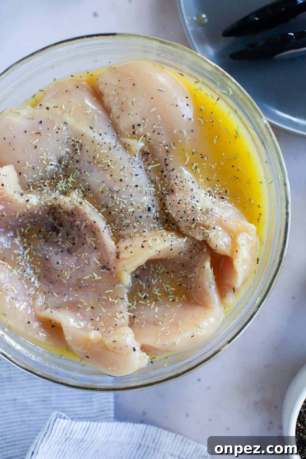 Chicken breasts fully covered with honey vinaigrette marinade and seasoned with spices.