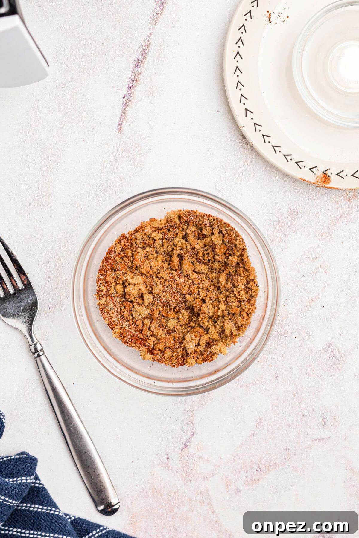 Small glass bowl with seasonings mixed together making the pork chop rub.