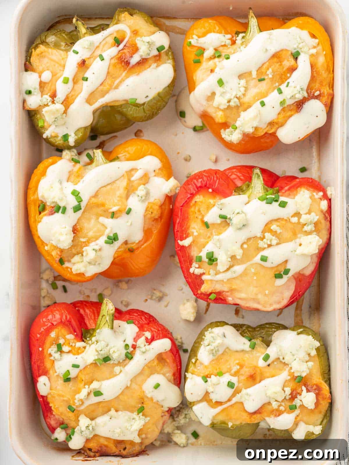 Buffalo Chicken Stuffed Bell Peppers 7 A tray of keto stuffed peppers with chicken and blue cheese crumbles.