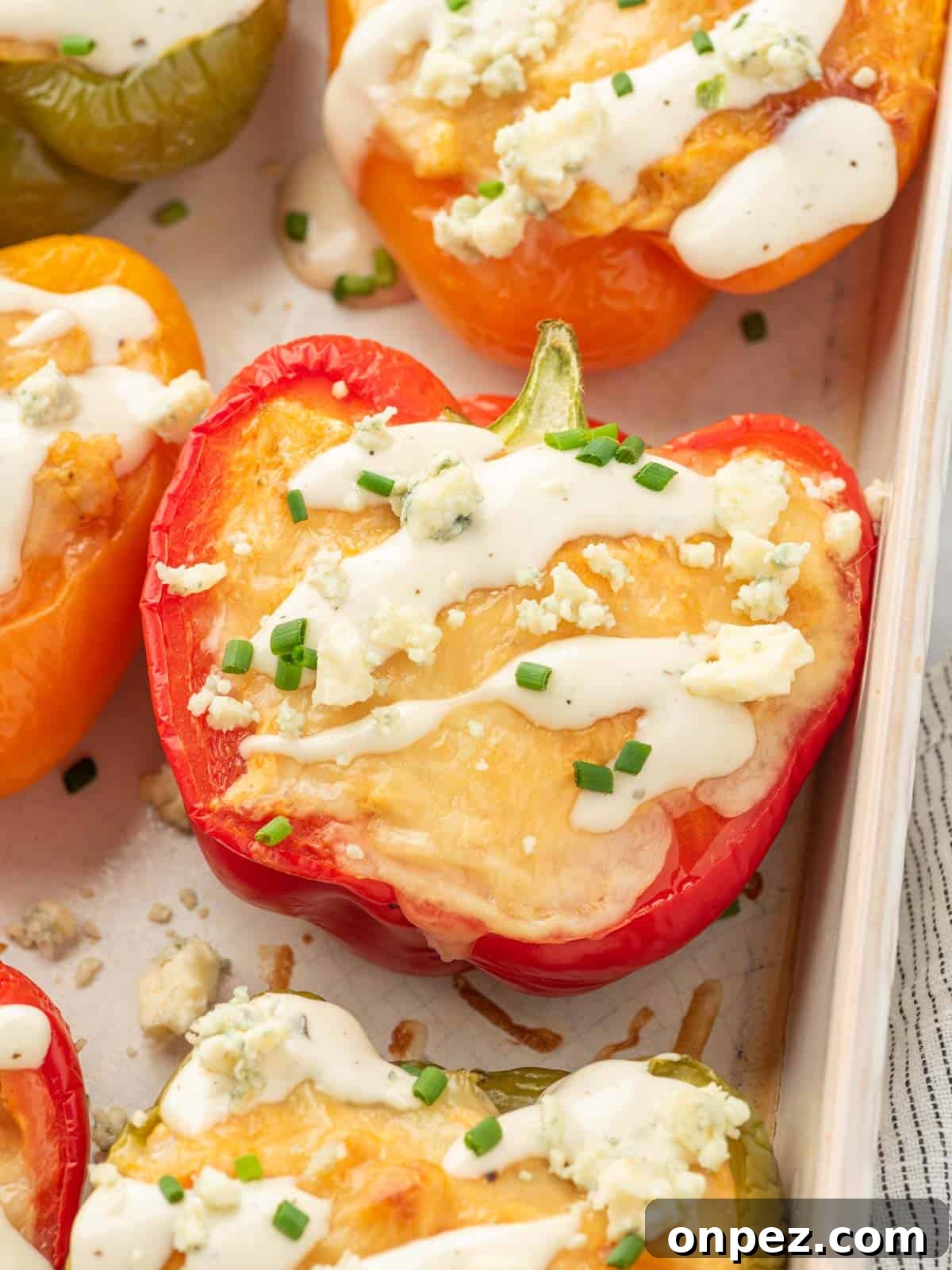 Buffalo Chicken Stuffed Bell Peppers 8 Closeup of buffalo chicken stuffed peppers in a dish.