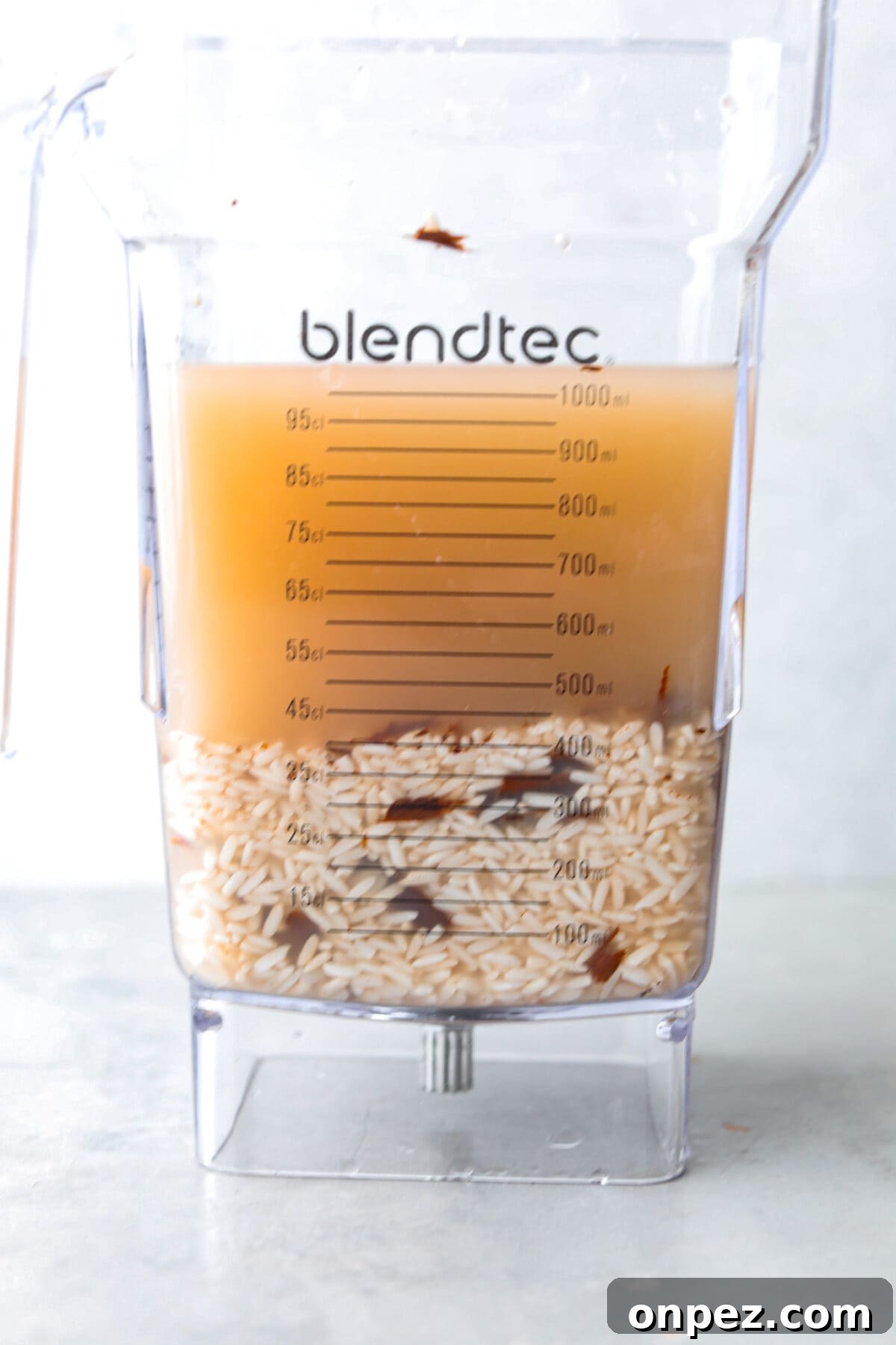 Blend the soaked rice mixture for horchata. Process photo of the rice water mixture added to a blender.