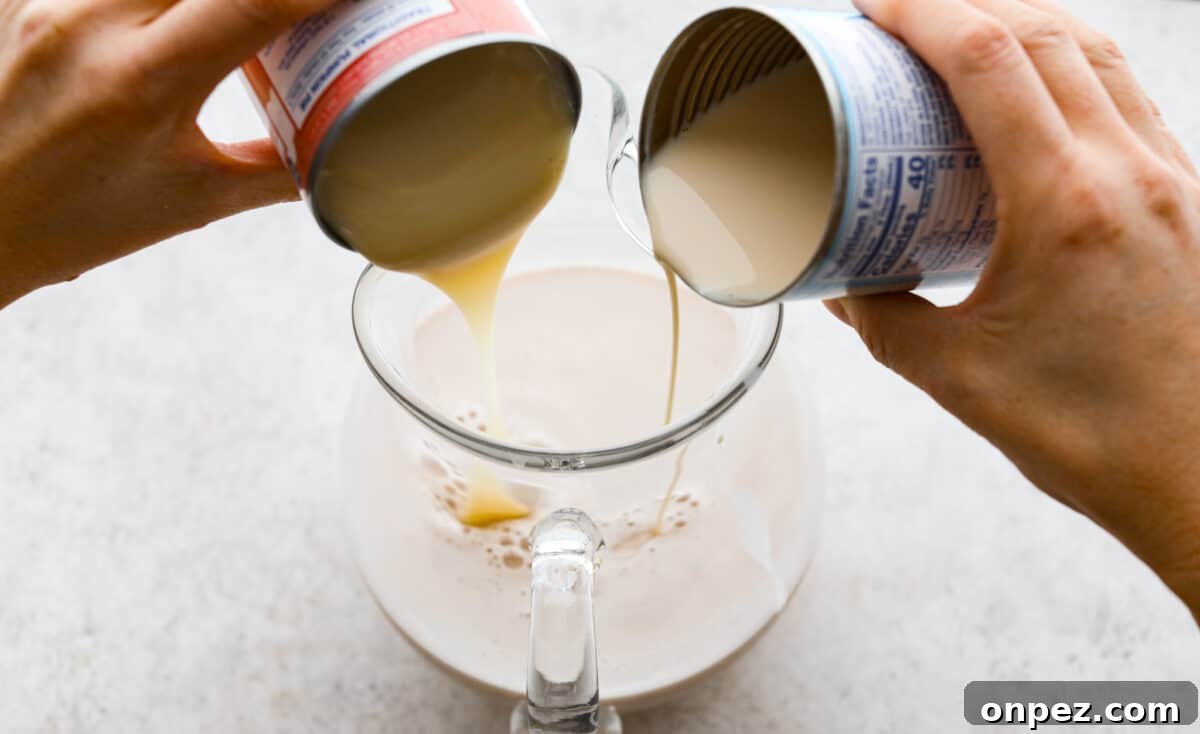 Add evaporated milk and sweetened condensed milk to the horchata base. Process photo of the evaporated milk and sweetened condensed milk pouring into the strained rice mixture.
