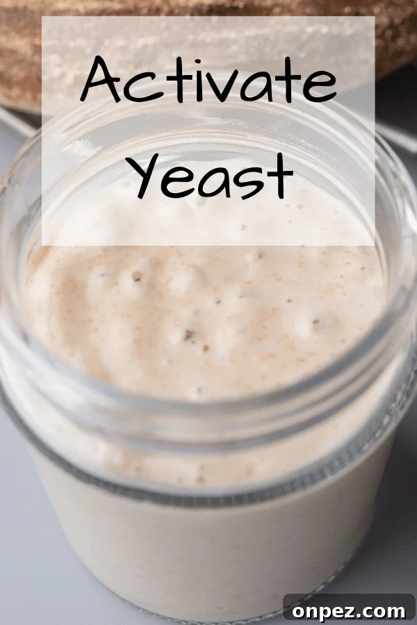 glass jar with foamy activated yeast inside