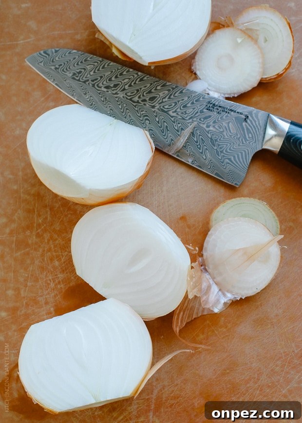 Halved onions on a wooden surface.