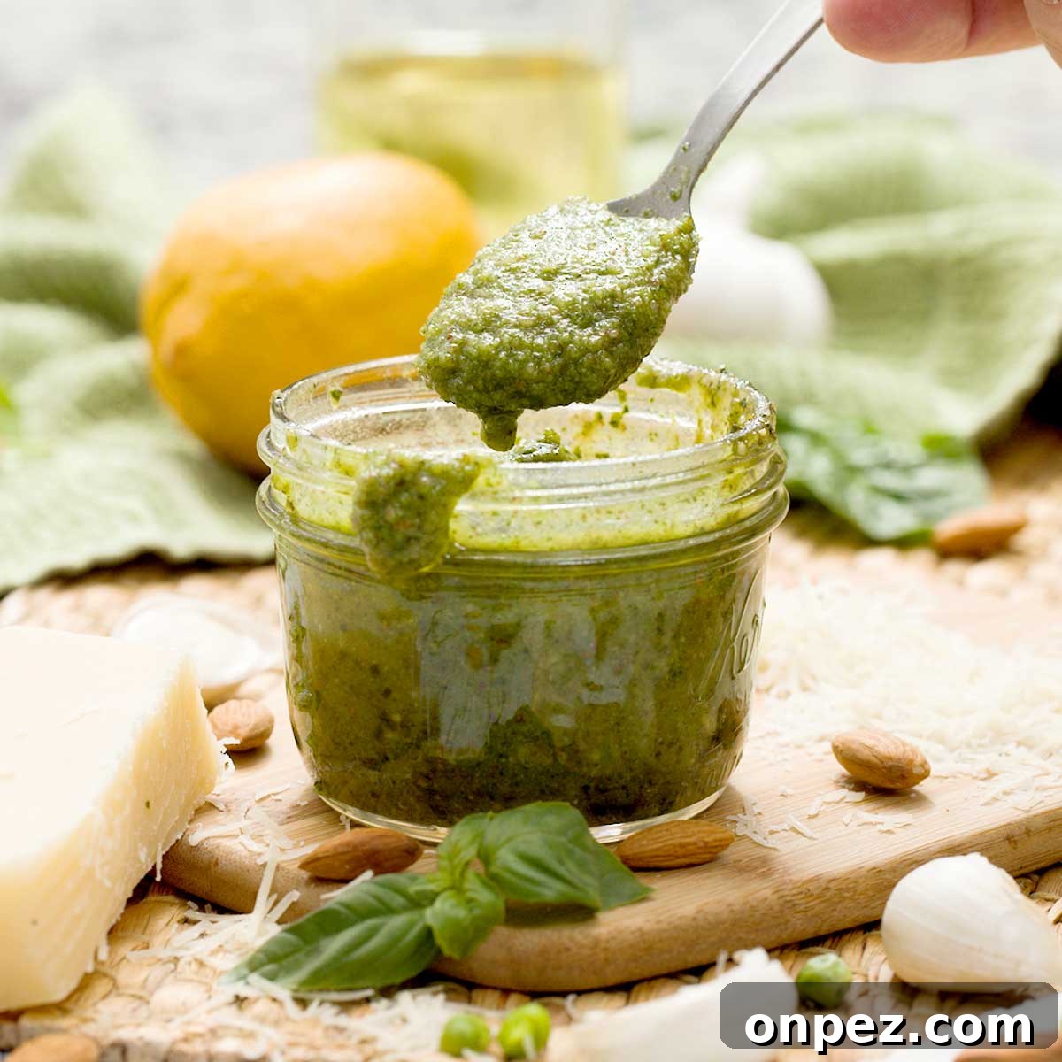 A mason jar with a batch of pesto sauce without pine nuts.