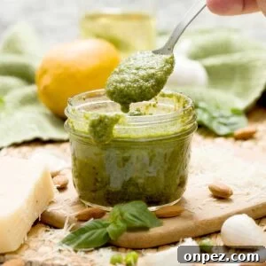 A mason jar with a batch of pesto sauce without pine nuts.