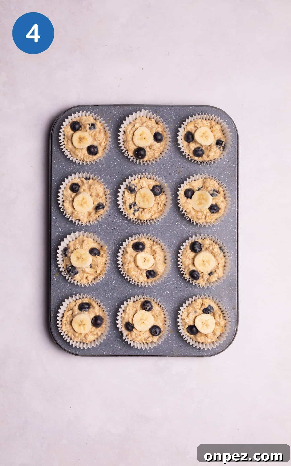 banana oatmeal muffins mixture in a muffin tin.