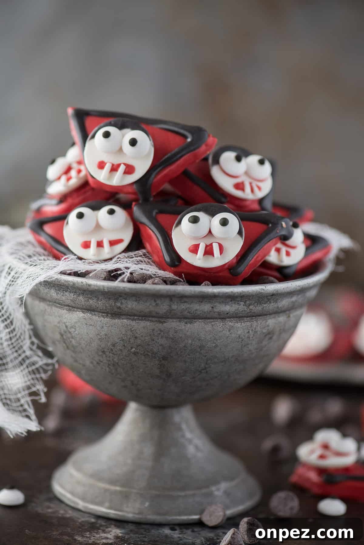 edible vampire treats made out of graham crackers and candy melts displayed in metal bowl