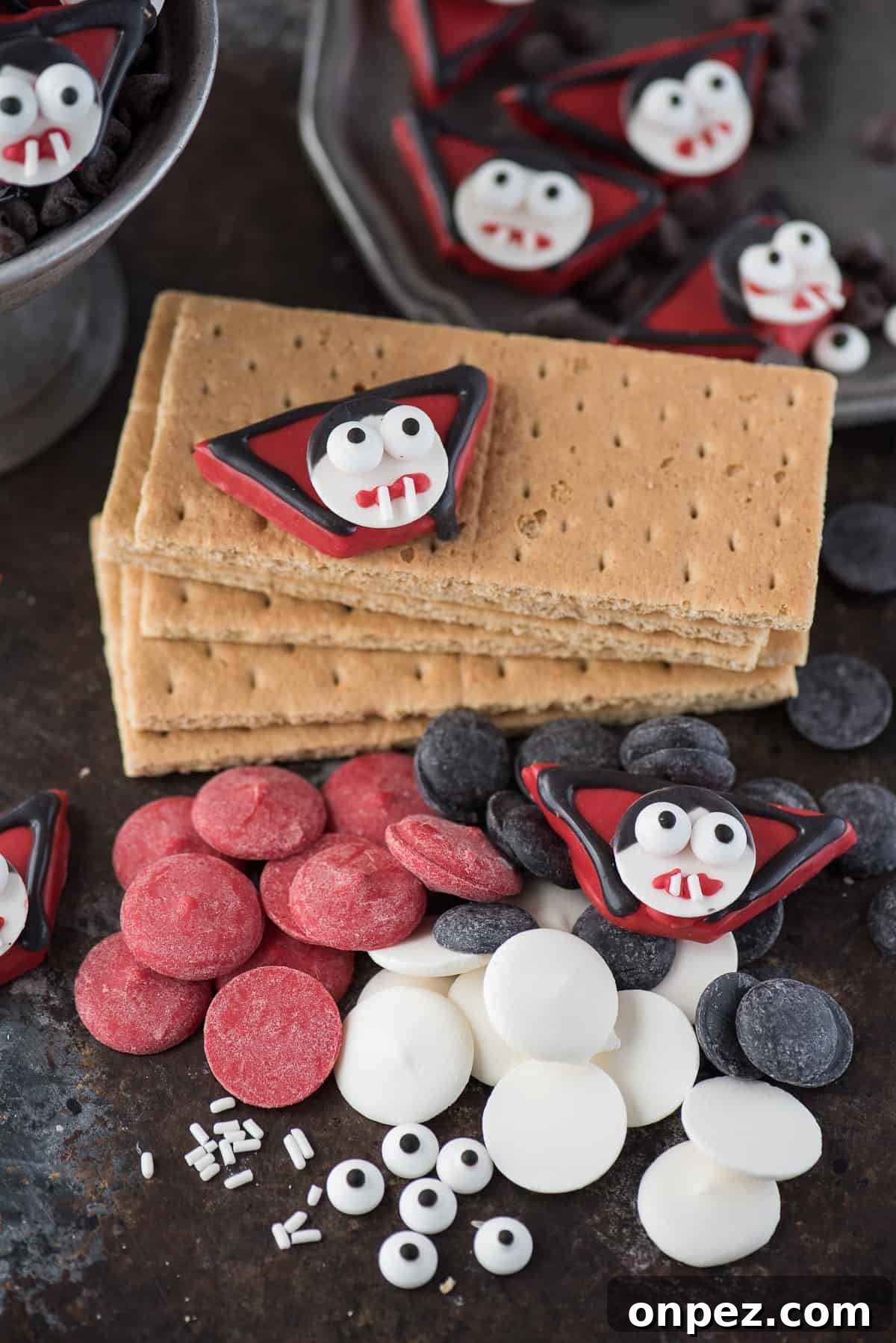 supplies to make edible vampire treats including graham crackers, red, white and black candy melts, and candy eye balls