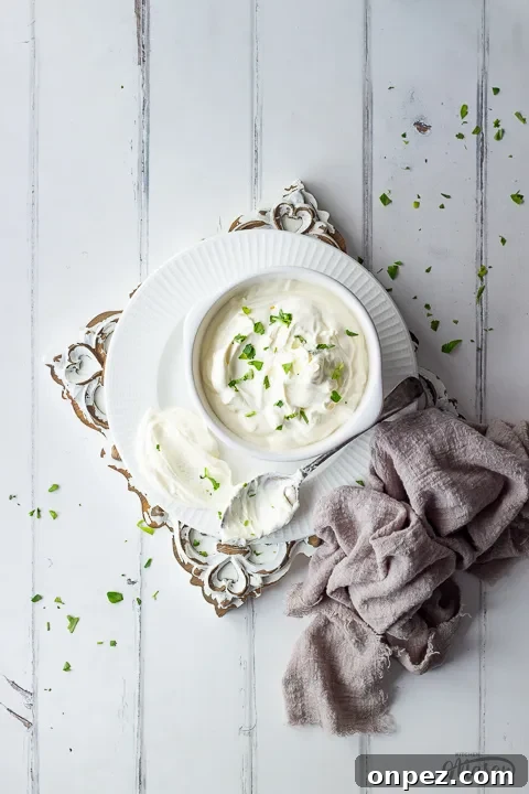 How to Substitute Creme Fraiche in the UK 6 A bowl of crème fraîche with a spoon on a wooden board