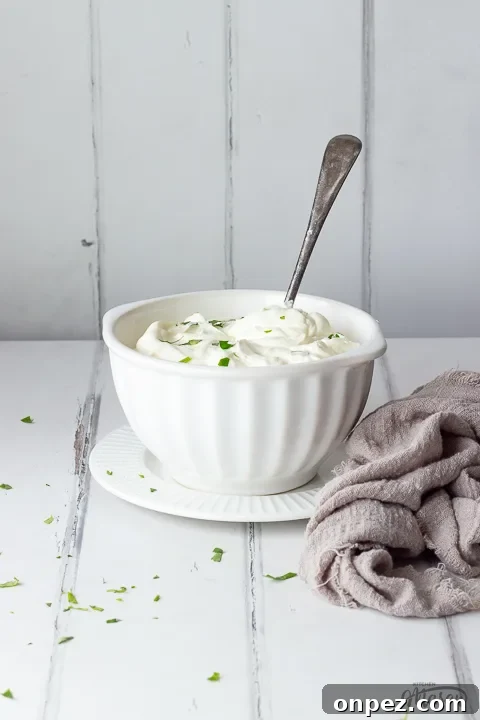 How to Substitute Creme Fraiche in the UK 9 A white bowl filled with crème fraîche scattered with parsley