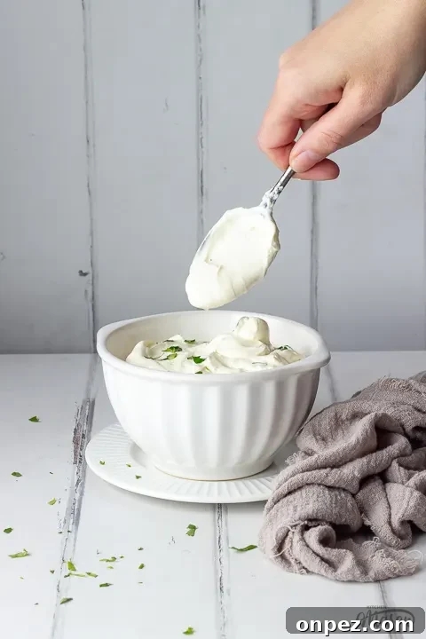 How to Substitute Creme Fraiche in the UK 5 Someone pulling a spoon out of a bowl of creme fraiche