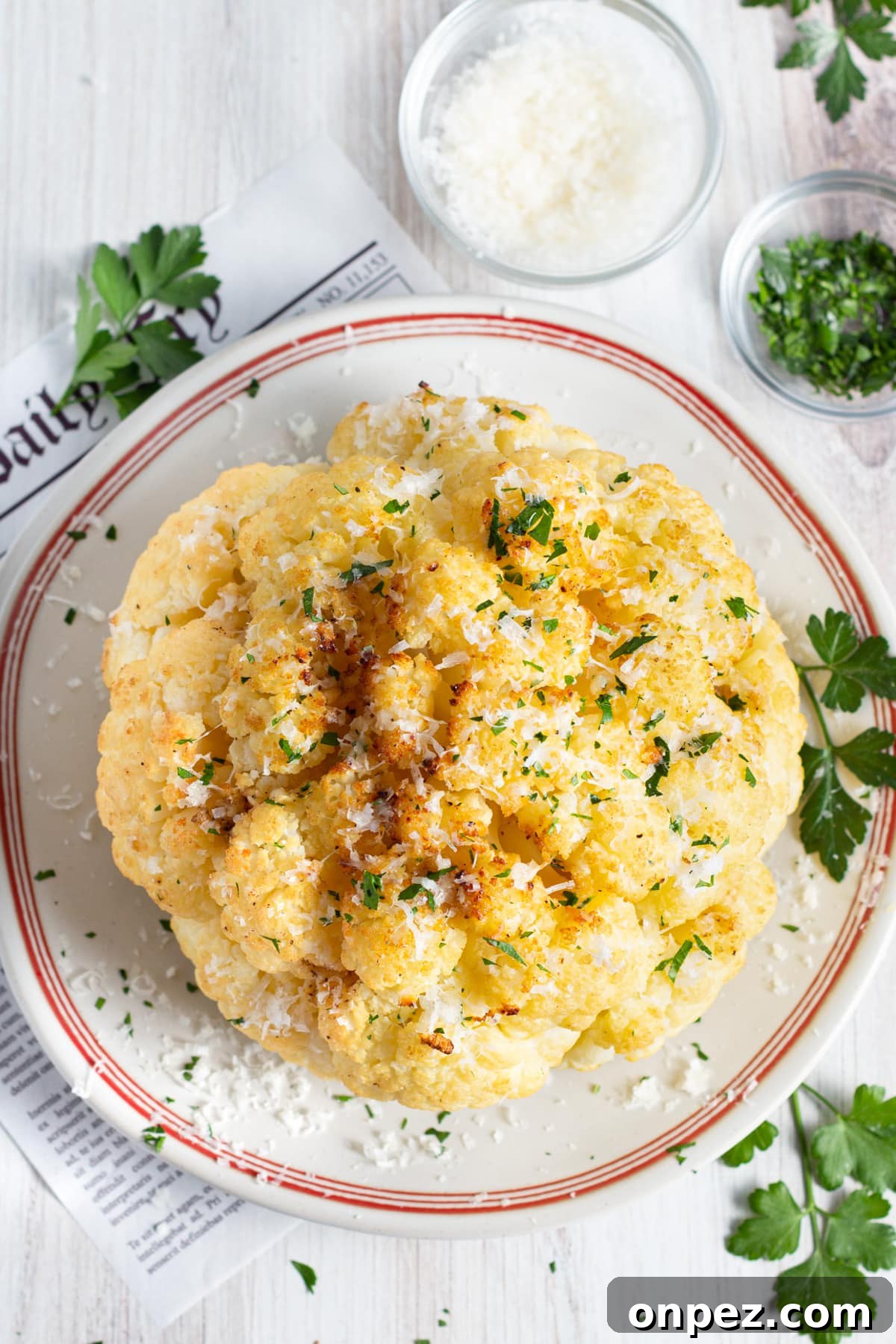 Smoked Cauliflower: How to Achieve Smoky, Tender Flavor 9 Picture of the cauliflower plated with bowls of parmesan and parsley.