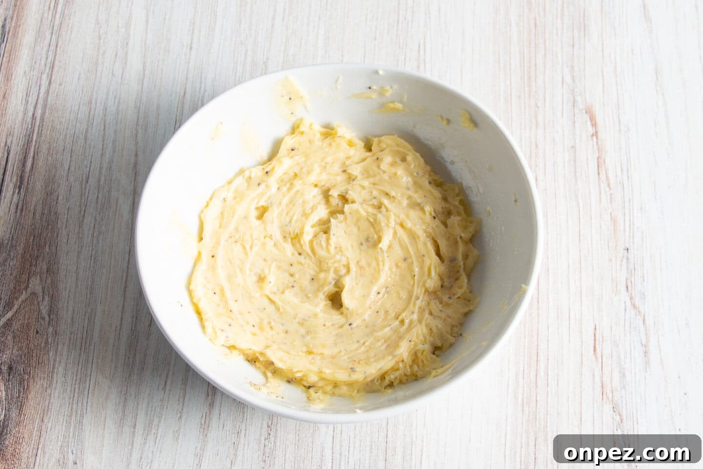 Smoked Cauliflower: How to Achieve Smoky, Tender Flavor 4 Picture of white bowl with garlic butter.