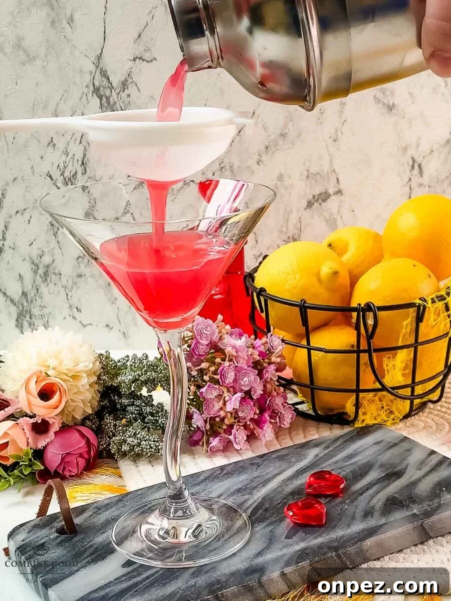 Fine strain the raspberry lemon martini into the serving glass.