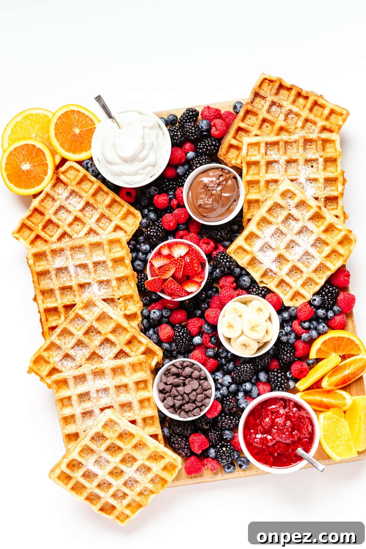Waffle breakfast board featuring german waffles, variety of toppings and fresh fruit.