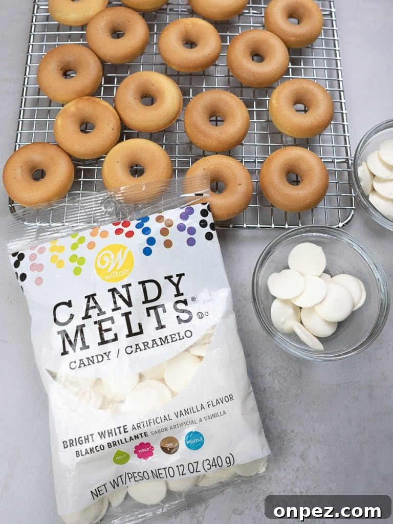 mini donuts on a rack with white candy melts